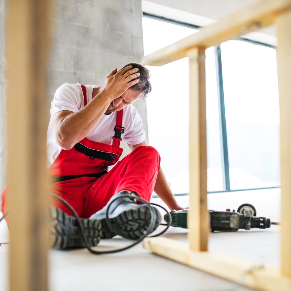 An accident of a man worker at the construction site.