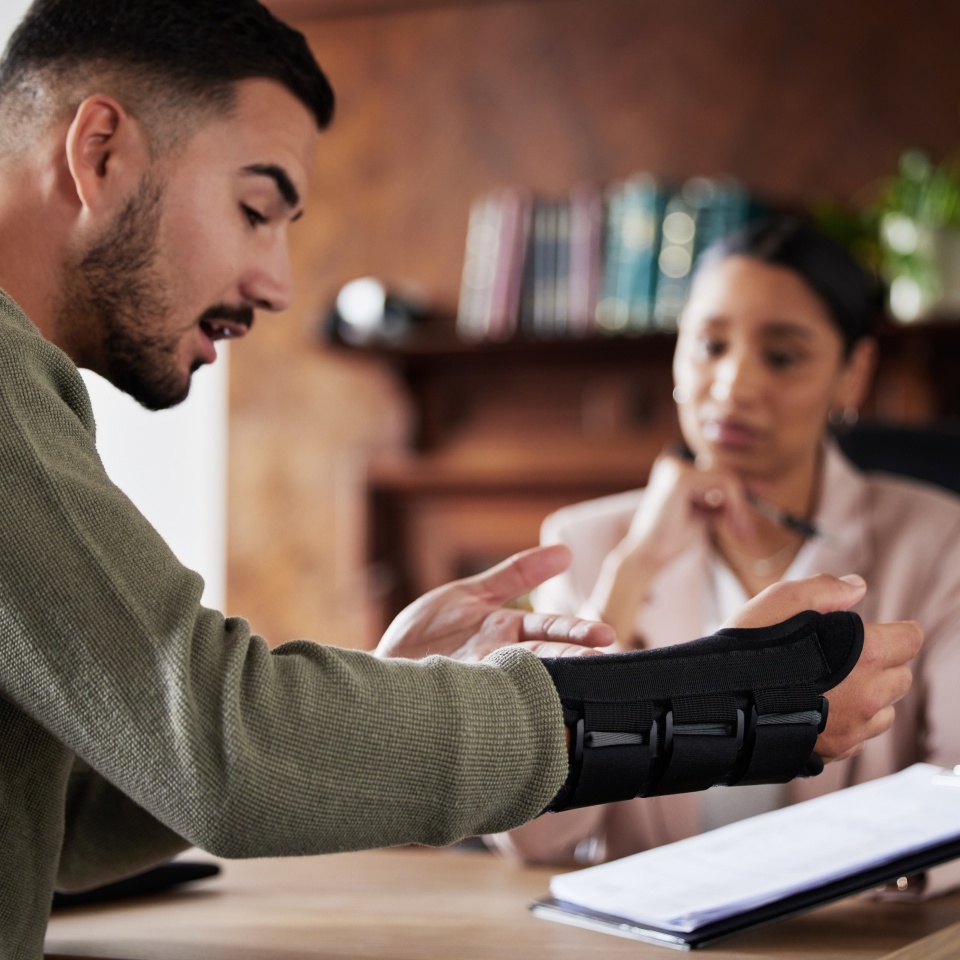 Legal labor law, injury or man with lawyer woman planning on documents for insurance, compliance and HR agreement. Consulting, advisor and male client for security claim or disability compensation